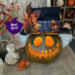 A Handmade spooky monster fall decoration with a whimsical toothy grin, a grungy top hat and candle. 